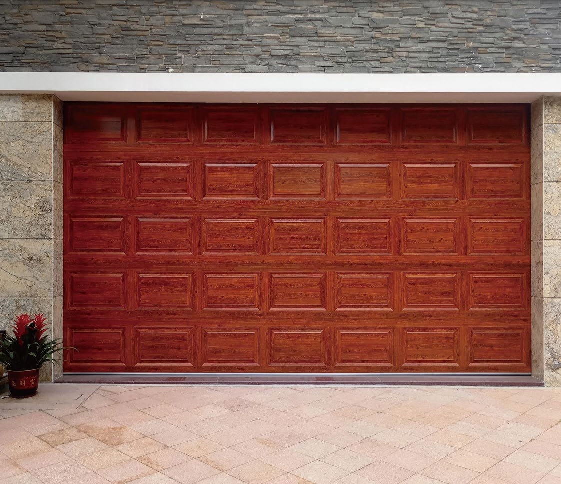 Deep red wood-grain raised-panel garage door set in stone
