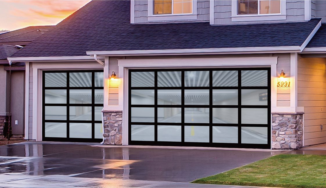 Two full-view glass and black aluminum garage doors on a shingled home at dusk
