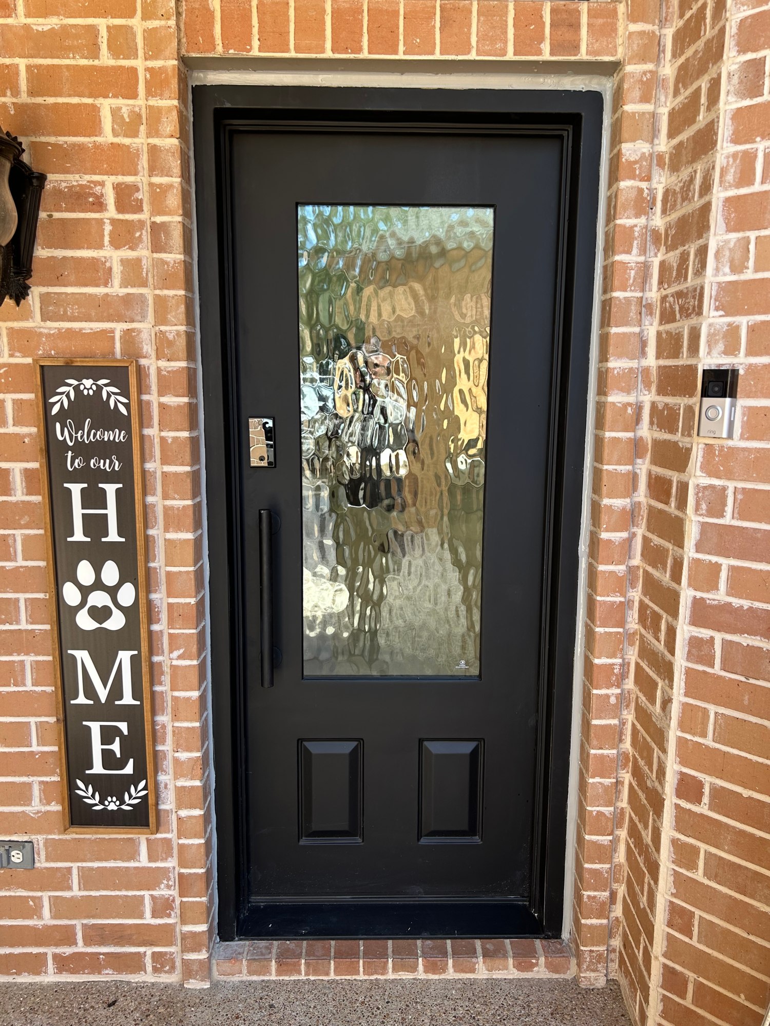 Single textured-glass entry in a brick opening